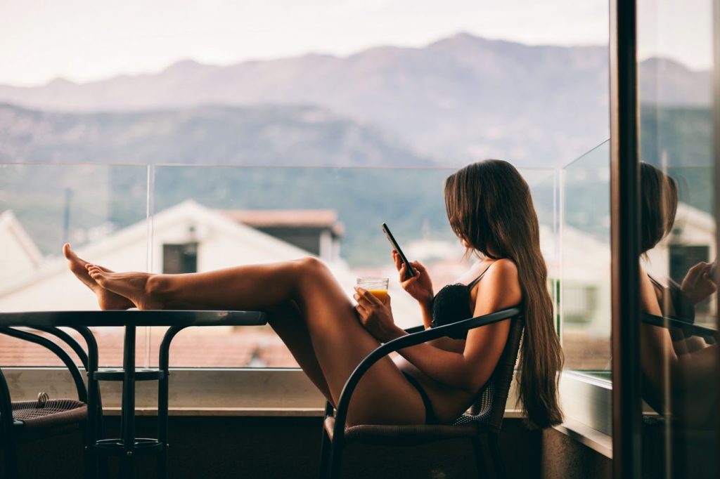 woman sitting on a chair while sexting